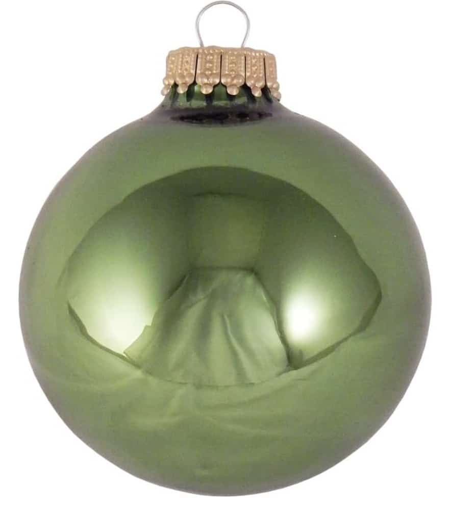 A shiny green Christmas ornament with a gold cap, reflecting light on its smooth surface. Its glossy finish gives a mirrored appearance, fitting perfectly among other Christmas tree decorations for festive flair.